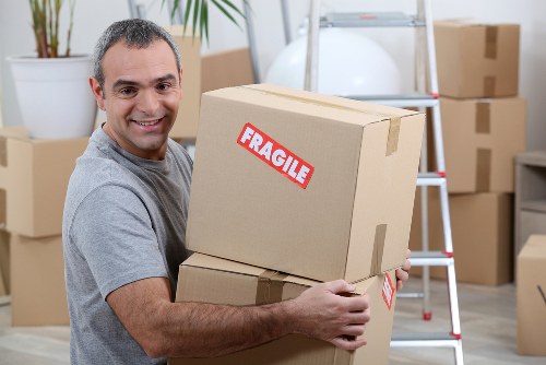 Man with van pricing overview in St Johns with moving boxes and furniture