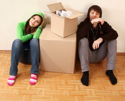 Movers carrying furniture through a residential property in St Johns
