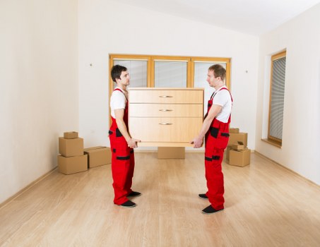 Staff using PPE while handling furniture during a removal job